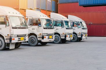 3 Line of cargo truck with container box for export import shipping at yard. logistic concept